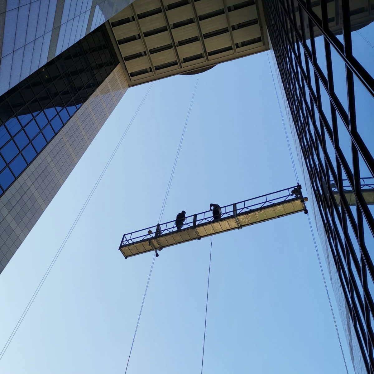 Suspended platform for high rise building facade work and vertical access
